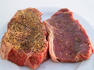 Seasoning the steaks.  I like a lot of season on the steak and my wife just a little bit.