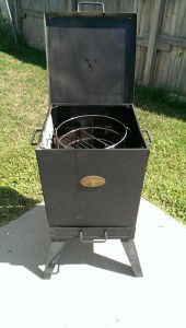 This small smoker is about 14" square and has a small charcoal basket in each corner. Works great!